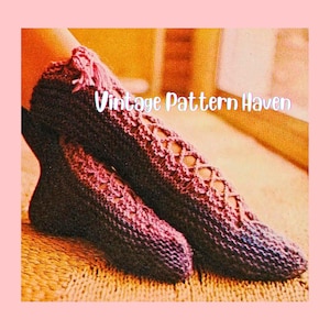 May include: Close-up of knitted slippers in shades of purple. The slippers have an openwork design on the top and a fringe detail at the ankle. The text "Vintage Pattern Haven" is displayed in white.