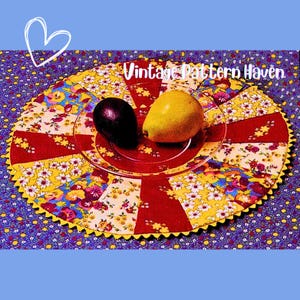 May include: A colorful, vintage-style placemat with a floral pattern and red accents. A clear glass plate holds a dark purple plum and a yellow pear. The text "Vintage Pattern Haven" is visible.