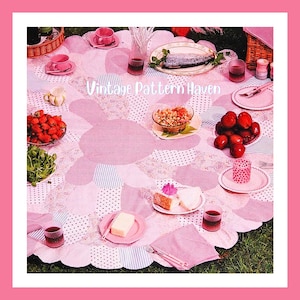 May include: A pink and white floral picnic blanket with various food items and tableware arranged on top. The scene includes strawberries, a fish, cake, and drinks. The text "Vintage Pattern Haven" is visible.