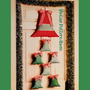 May include: A handmade Christmas tree decoration made of fabric, featuring red, green, and white patterns. The tree is adorned with red and white striped bows. The text "Vintage Pattern Haven" is visible on the right side.