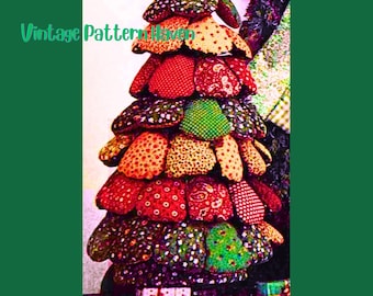 May include: A handmade Christmas tree made of colorful fabric patches. The tree is decorated with red, green, yellow, and patterned fabrics. The text "Vintage Pattern Haven" is visible on the left side of the image.