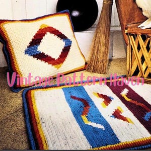 May include: A crocheted pillow and rug set with a geometric design in shades of red, yellow, blue, and white. The pillow has a diamond shape in the center, while the rug has a series of wavy lines.