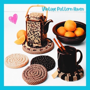 May include: A square ceramic teapot with a floral pattern, a dark brown bowl filled with oranges, a black mug with cinnamon sticks, and several coiled fabric coasters in black, brown, and beige patterns. The text Vintage Pattern Haven is visible.