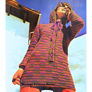 May include: A vintage crochet pattern for a hooded sweater with a striped design in shades of orange, purple, and green. The sweater has a tie closure at the front and is shown being worn by a model against a white background.