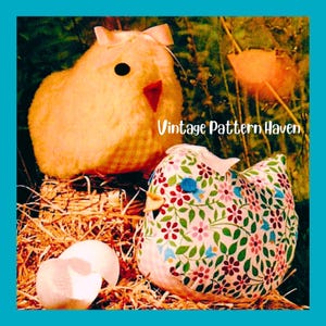 May include: Two plush fabric chickens, one solid yellow with a gingham base and one white with a colorful floral pattern, featuring small bows on their heads and black or blue eyes, resting on straw with two white eggshells nearby. Text: Vintage Pattern Haven.