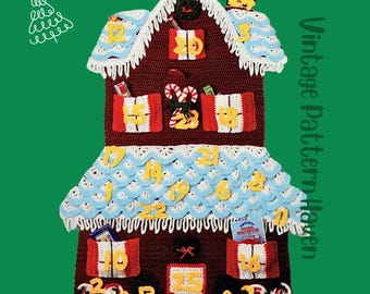 May include: A handmade crochet Christmas advent calendar in the shape of a gingerbread house. The house is primarily burgundy with white, blue, and yellow accents. It features numbered pockets for each day of Advent, with decorative candy and gifts.