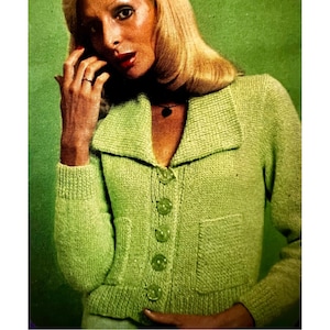 May include: A green knitted cardigan with a wide collar, button closure, and two patch pockets.