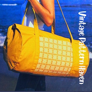 May include: Mustard yellow duffel bag with a woven geometric pattern on the front. The bag has a zipper closure, shoulder strap, and two handles. The text "Vintage Pattern Haven" is printed vertically on the right side.