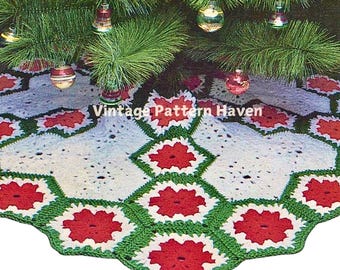 May include: A crocheted Christmas tree skirt with a white center and a green and red border. The skirt is decorated with red flowers with white centers.