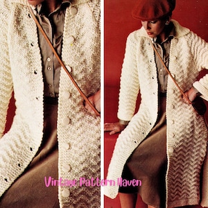 May include: Cream-colored, long knitted coat with a button-up front and a chevron pattern. The coat has a collar and long sleeves. The image shows a vintage fashion style.