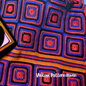 May include: A colorful, handmade crochet blanket with a repeating square pattern in red, blue, and black. The blanket has an orange stripe and the text "Vintage Pattern Haven" in white. The blanket is a vibrant piece of home decor.