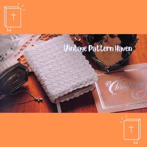 May include: A white crocheted book cover with a scalloped edge, featuring the text "Vintage Pattern Haven". A silver-toned cross necklace and a card with the word "Christening" are also visible.