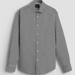 Pode incluir: Camisa de manga comprida com um cl&aacute;ssico padr&atilde;o de pata de galo em preto e branco. A camisa tem gola abotoada e um corte sob medida, adequado para v&aacute;rias ocasi&otilde;es. O tecido parece ser um material tecido.