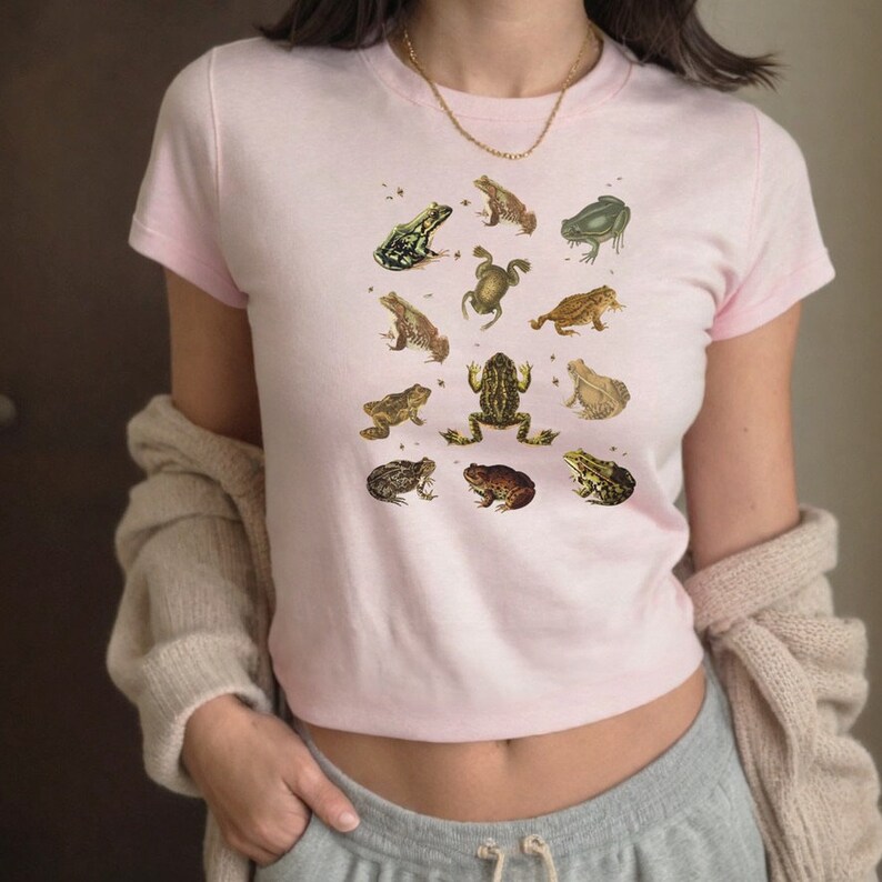 Vintage Frog and Toad graphic Shirt: twelve vintage illustration of frogs and toads decorated with flys printed on a gildan 5000b youth shirt. Here wear by a woman as a trendy 90s baby tee.