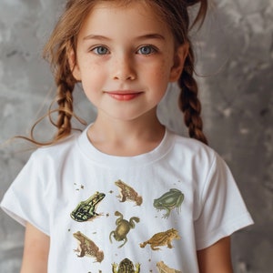 Vintage Frog and Toad graphic Shirt: twelve vintage illustration of frogs and toads decorated with flys printed on a gildan 5000b youth shirt. Here wear by a girl