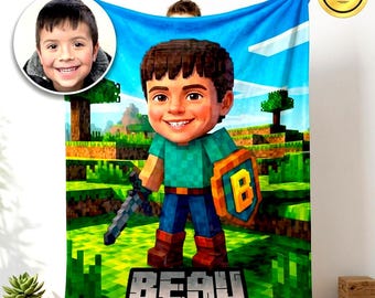 May include: A custom fleece blanket featuring a pixelated character illustration based on a child's photo. The design includes a blocky landscape, a sword, a shield with the letter B, and the name BEAU in large block letters at the bottom.