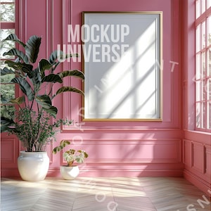 May include: A gold-framed picture frame hangs on a pink wall in a room with a hardwood floor. Two potted plants sit on the floor. The text "MOCKUP UNIVERSE" is visible on the picture frame.