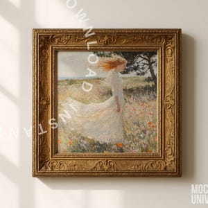 May include: A framed artwork featuring a woman in a white dress standing in a field of flowers. The painting has a gold ornate frame. The woman's red hair is blowing in the wind. The artwork is mounted on a white wall.