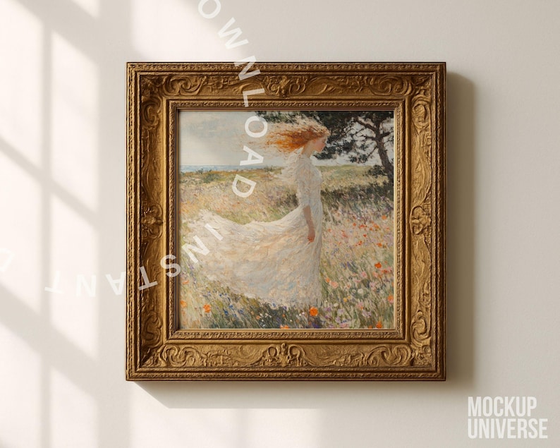 May include: A framed artwork featuring a woman in a white dress standing in a field of flowers. The painting has a gold ornate frame. The woman's red hair is blowing in the wind. The artwork is mounted on a white wall.