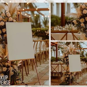 May include: A white blank sign on an easel with a floral arrangement of white roses and pampas grass in front of it. The sign is set up in an outdoor wedding venue with string lights and wooden chairs.