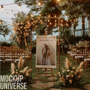 May include: A wedding welcome sign with a rustic wooden easel, featuring a photo of the couple and the text "Welcome to the Wedding of Avery and Davis, February 25, 2024". The sign is surrounded by greenery and flowers, with string lights in the background.