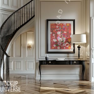 May include: An interior scene featuring a black console table with a lamp and a framed floral print. A curved staircase with a black railing is visible. The walls are white with decorative molding, and the floor has a wood grain pattern.