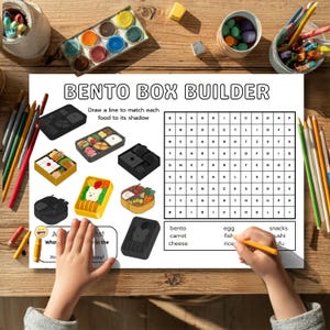 May include: A colorful educational worksheet titled "Bento Box Builder" with illustrations of bento boxes and a word search. The worksheet includes the text "Draw a line to match each food to its shadow". A child's hand is holding a pencil.