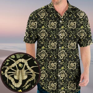 May include: A black button-up shirt with a short sleeve design featuring a repeating pattern of a beige alien creature with a floral background.
