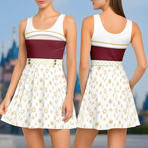 May include: A sleeveless dress featuring a white bodice with gold trim, a burgundy midsection, and a white skirt with a gold pattern. The dress has a fitted bodice and a flared skirt, with a decorative waistband and gold buttons.