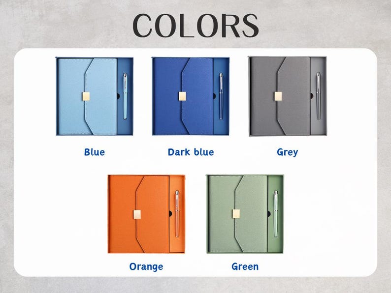 May include: An assortment of five boxed sets, each containing a notebook and pen. The sets are in various colors: blue, dark blue, grey, orange, and green. The word "COLORS" is displayed at the top of the image.