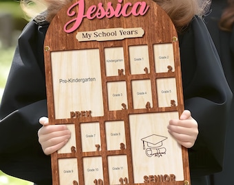 May include: A wooden photo frame with a personalized inscription "Jessica My School Years". The frame has 12 slots for photos, each labeled with a grade level from Pre-Kindergarten to Senior.