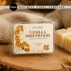 May include: A clear plastic clamshell container of soy wax melts with a cream-coloured label. The label features autumn maple leaves, the text "Solace Candle Co.", "VANILLA DRIFTWOOD", "(vanilla, amber, sandalwood, cedarwood)", "SOY WAX MELTS", and "1.8 oz | 50g".