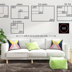The image is a living room with a white sofa and colorful throw pillows. Above the sofa, there are four black and white geometric shapes representing different ratios, such as 4:5 ratio, 5:4 ratio, and 3:2 ratio. The image also includes a small black circle with the text "COLOR TRAVEL" inside it.