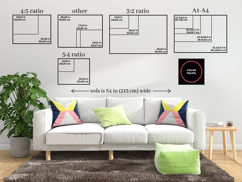 The image is a living room with a white sofa and colorful throw pillows. Above the sofa, there are four black and white geometric shapes representing different ratios, such as 4:5 ratio, 5:4 ratio, and 3:2 ratio. The image also includes a small black circle with the text "COLOR TRAVEL" inside it.