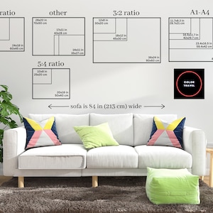 The image is a living room with a white sofa and colorful throw pillows. Above the sofa, there are four black and white geometric shapes representing different ratios, such as 4:5 ratio, 5:4 ratio, and 3:2 ratio. The image also includes a small black circle with the text "COLOR TRAVEL" inside it.
