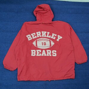 Könnte beinhalten: Rote Kapuzenjacke mit dem weißen Text "BERKLEY BEARS", einer Football-Grafik und der Nummer "18". Die Jacke hat eine Kapuze mit Kordelzug und lange Ärmel. Die Jacke ist aus einem leichten Material gefertigt.