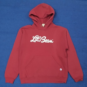 May include: A red hooded sweatshirt with the white text "L.L.Bean" across the chest. The sweatshirt has a kangaroo pocket and a drawstring hood. The garment is made of a soft material.