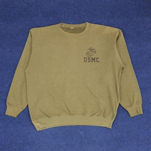 May include: A green long-sleeved sweatshirt with the USMC logo on the front.