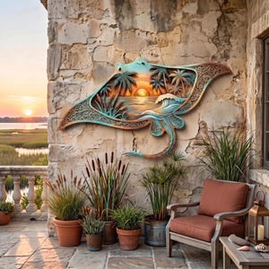 May include: A multi-layered wooden wall art piece shaped like a manta ray, featuring a sunset scene with palm trees, ocean waves, and intricate filigree patterns in shades of teal, orange, and brown, mounted on a textured stone wall.