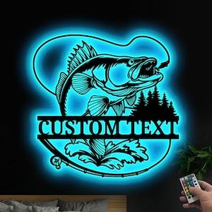 May include: A blue neon sign featuring a silhouette of a fish leaping from the water with a fishing rod and line. The sign displays "CUSTOM TEXT" in a black banner.