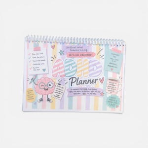 May include: A spiral-bound ADHD planner with a pastel striped background. The cover features a cartoon brain with glasses, a coffee mug, and text including "Brilliant mind. Chaotic timing," "LET'S GET ORGANISED," and "ADHD Planner" with various notes.