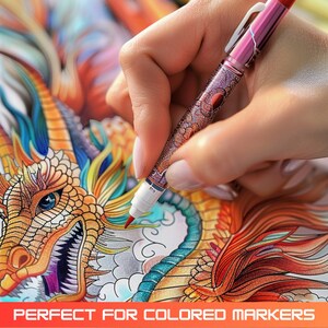 May include: A hand holding a pink and silver marker pen with a white tip, coloring in a detailed drawing of a dragon with gold, red, blue, and green scales. The dragon is on a white background.