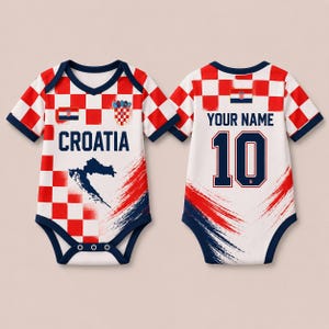 May include: A short-sleeved baby bodysuit featuring a red and white checkered pattern, the text CROATIA, a map of Croatia, and the Croatian coat of arms. The back displays the text YOUR NAME, the number 10, and a small Croatian flag graphic.