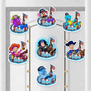 May include: A collection of seven cartoon character stickers, each in a pool float with an American flag and a bottle. The characters include a purple character, Mr. Potato Head, a blue dinosaur, a cowgirl, Buzz Lightyear, a cowboy, and a blue pig. Each float has the word "NAME" on it.