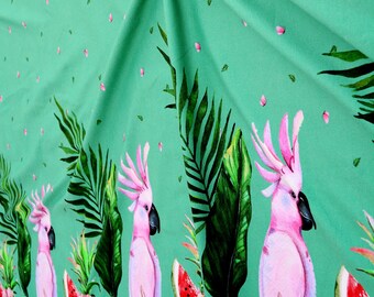 Green cotton jersey knit fabric with pink parrot print