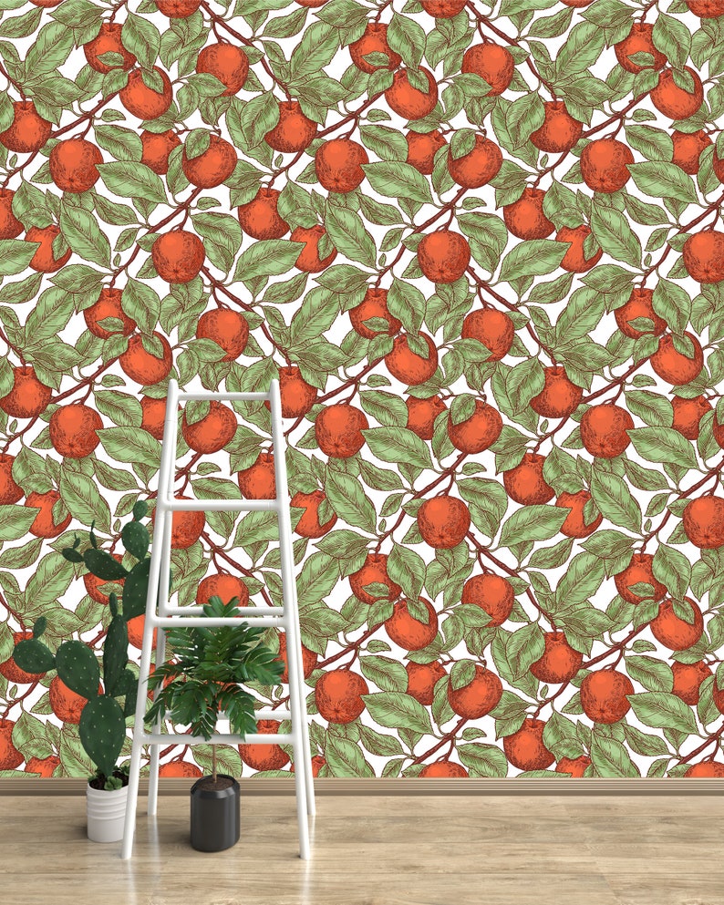 May include: A white background with a repeating pattern of red apples and green leaves. A white ladder is in the foreground with two potted plants.