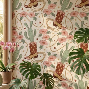 May include: Wallpaper with a repeating pattern of cowboy boots, cacti, pink flowers, ropes, and stars on a cream background. The boots are brown and tan, and the cacti have smiling faces. The flowers are pink with green leaves.