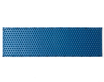 May include: A blue plastic mat with a grid of small, round bumps. The mat is designed to provide traction and support.