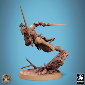May include: A detailed figurine of a warrior in mid-air, holding two swords. The figure is clad in armor and is posed dynamically above a textured, brown base. The base has a tree trunk and branches. The background is a gradient of blue.
