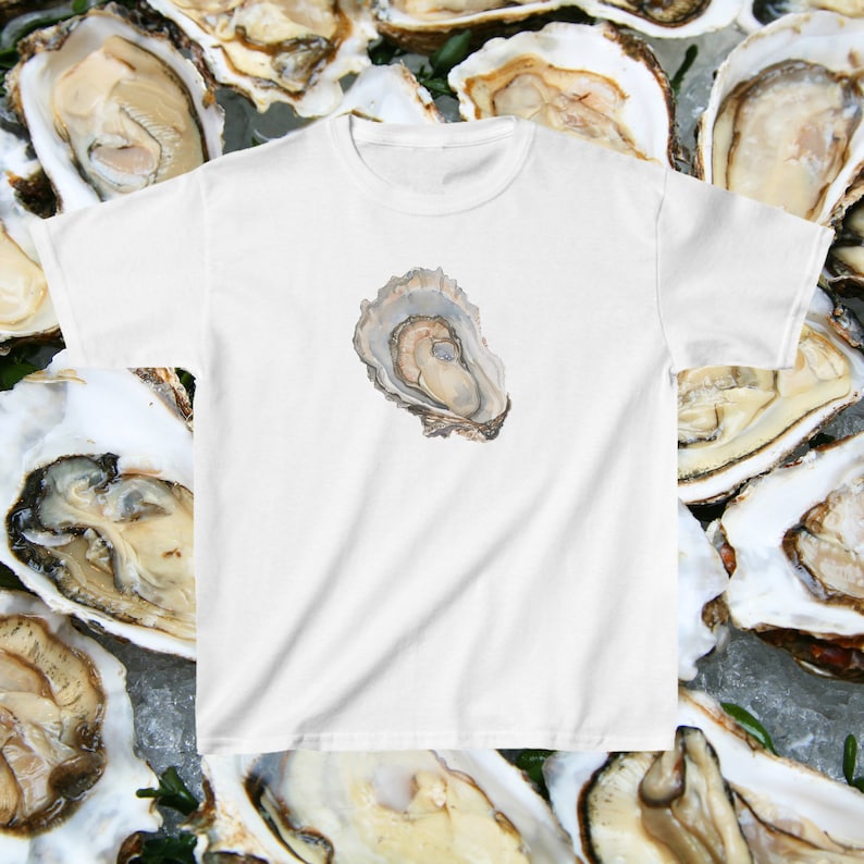 May include: White t-shirt featuring a watercolour illustration of an oyster shell on the front.